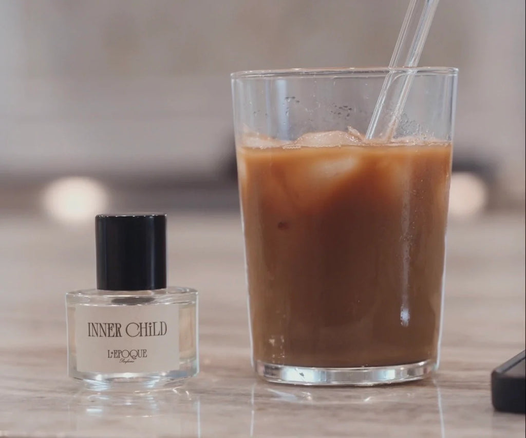 Inner Child Eau de Parfum by L'Époque Parfums styled with an iced coffee — a Mother's Day fragrance