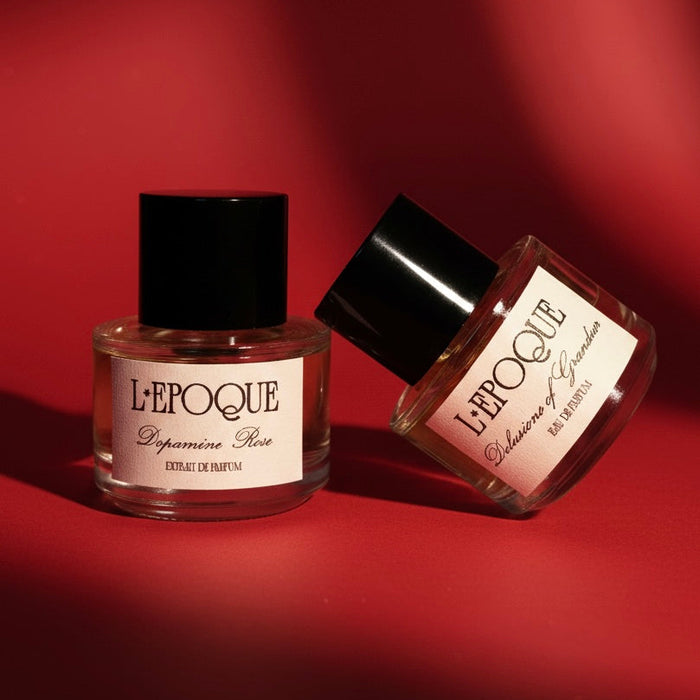 Two L'Epoque perfume bottles on a red background