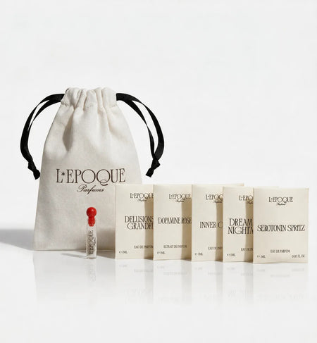 L'Epoque Parfums Discovery Set with five 1mL eau de parfum samples — Delusions of Grandeur, Dopamine Rose, Inner Child, Dreams and Nightmares, and Serotonin Spritz — with glass spray vial and cotton drawstring pouch