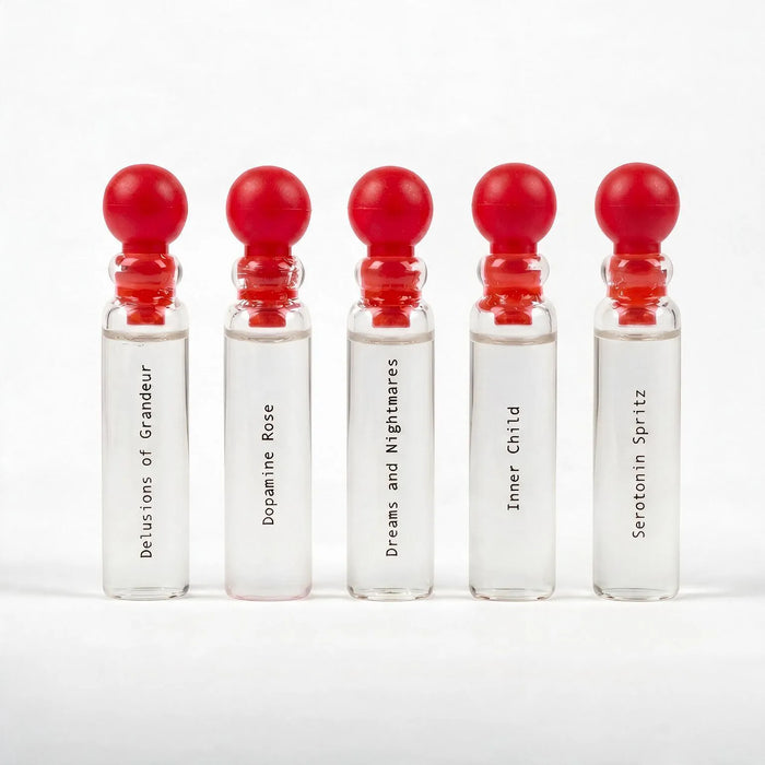 Five L'Epoque Parfums 1mL sample vials with red ball caps, labeled Delusions of Grandeur, Dopamine Rose, Dreams and Nightmares, Inner Child, and Serotonin Spritz
