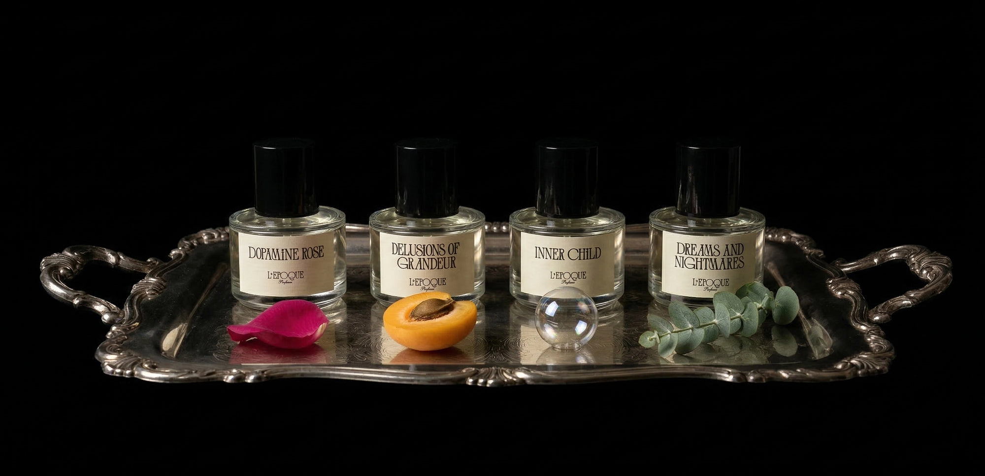 Dopamine Rose, Delusions of Grandeur, Inner Child, and Dreams and Nightmares Extrait de Parfum by L'Epoque Parfums on a silver tray